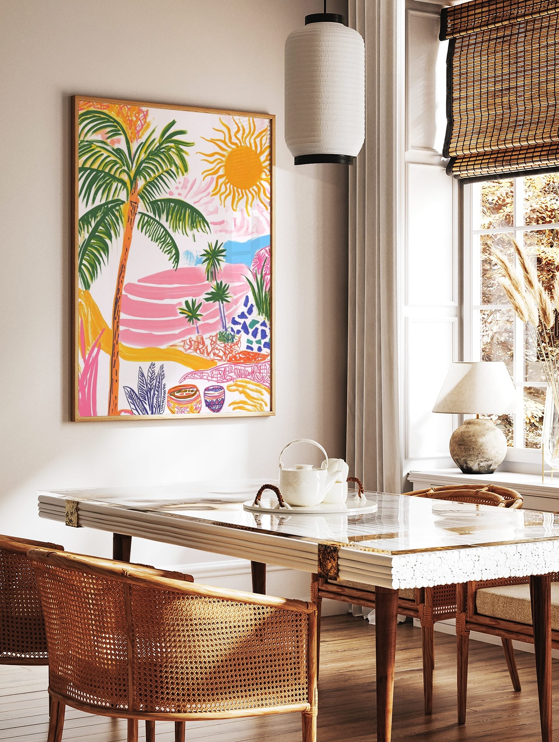 Colourful tropical landscape art print with palm trees, bright sun, pink terraced hills, and blue, in a styled room mockup