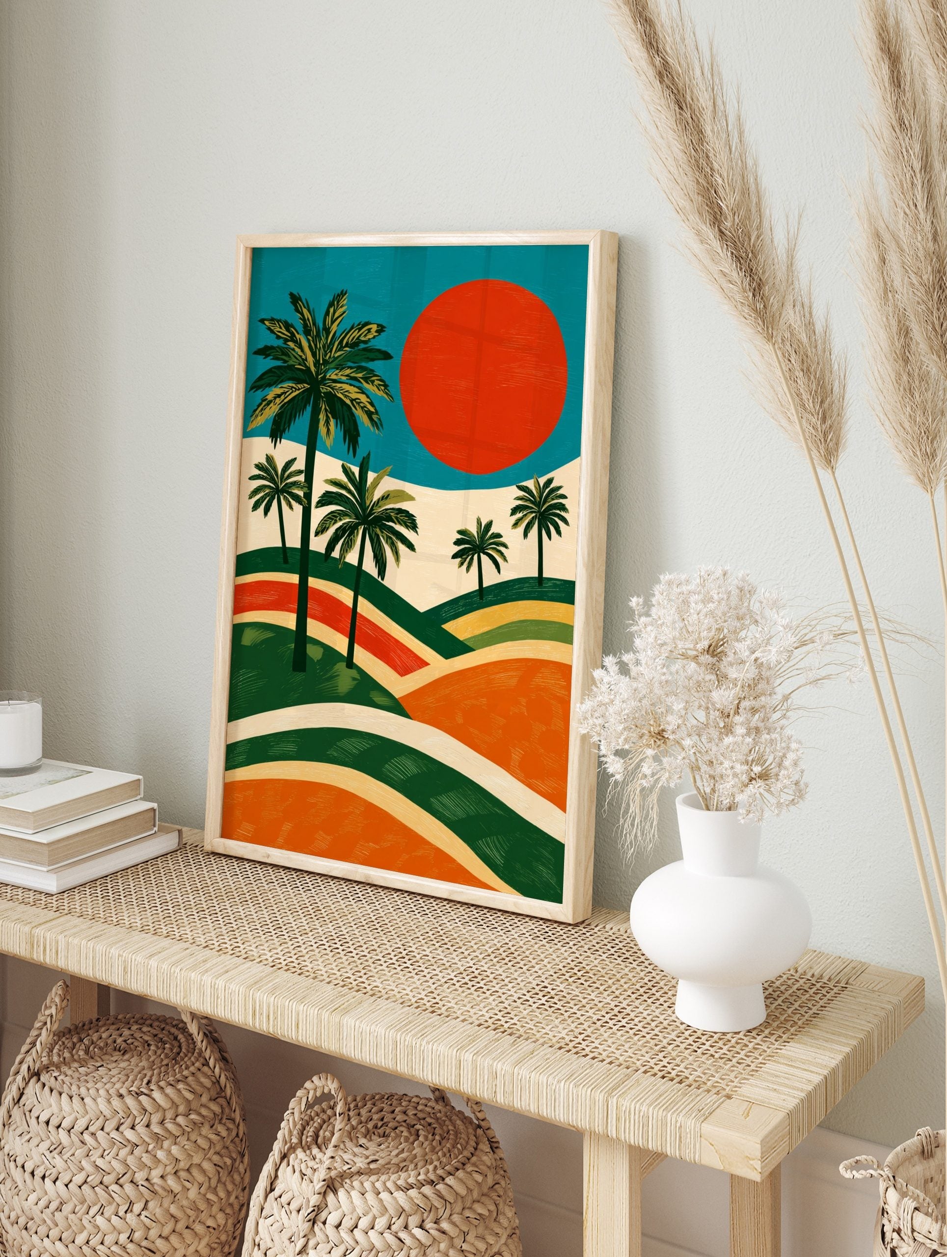 Illustrative landscape art print with green palm trees, large red sun, and layered orange and, in an alternate framed mockup