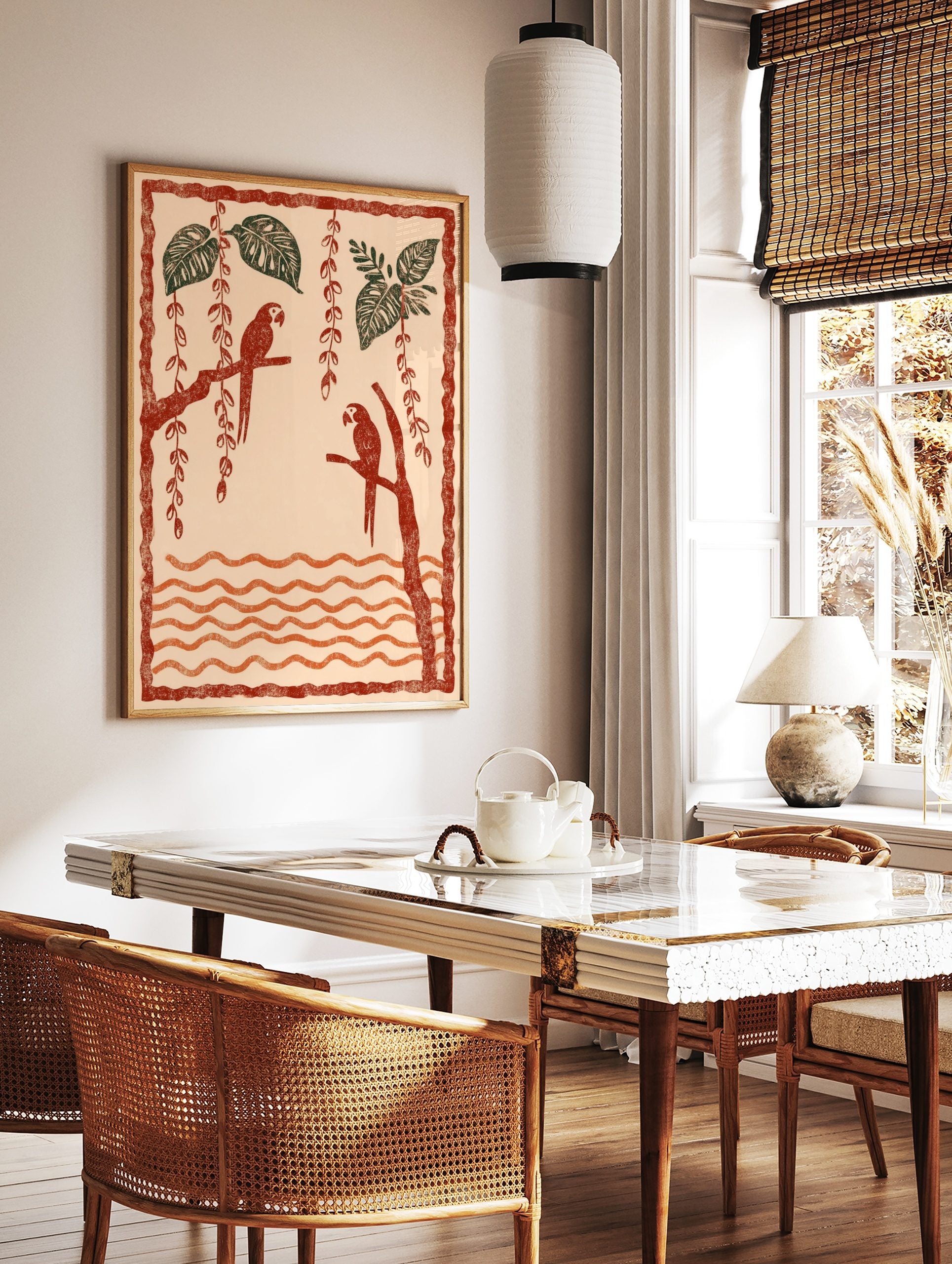 Illustrative art print of two red parrots on branches with green tropical leaves and orange wavy, in a styled room mockup