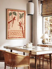 Illustrative art print of two red parrots on branches with green tropical leaves and orange wavy, in a styled room mockup
