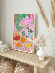 Tropical still life illustration with pink orchids, green leaves, lychees, pineapple, in an alternate framed mockup
