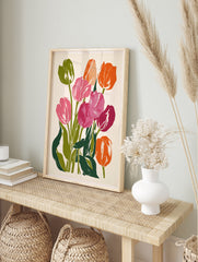 Vibrant tulip flower botanical art print with pink and orange petals and green leaves on a, in an alternate framed mockup
