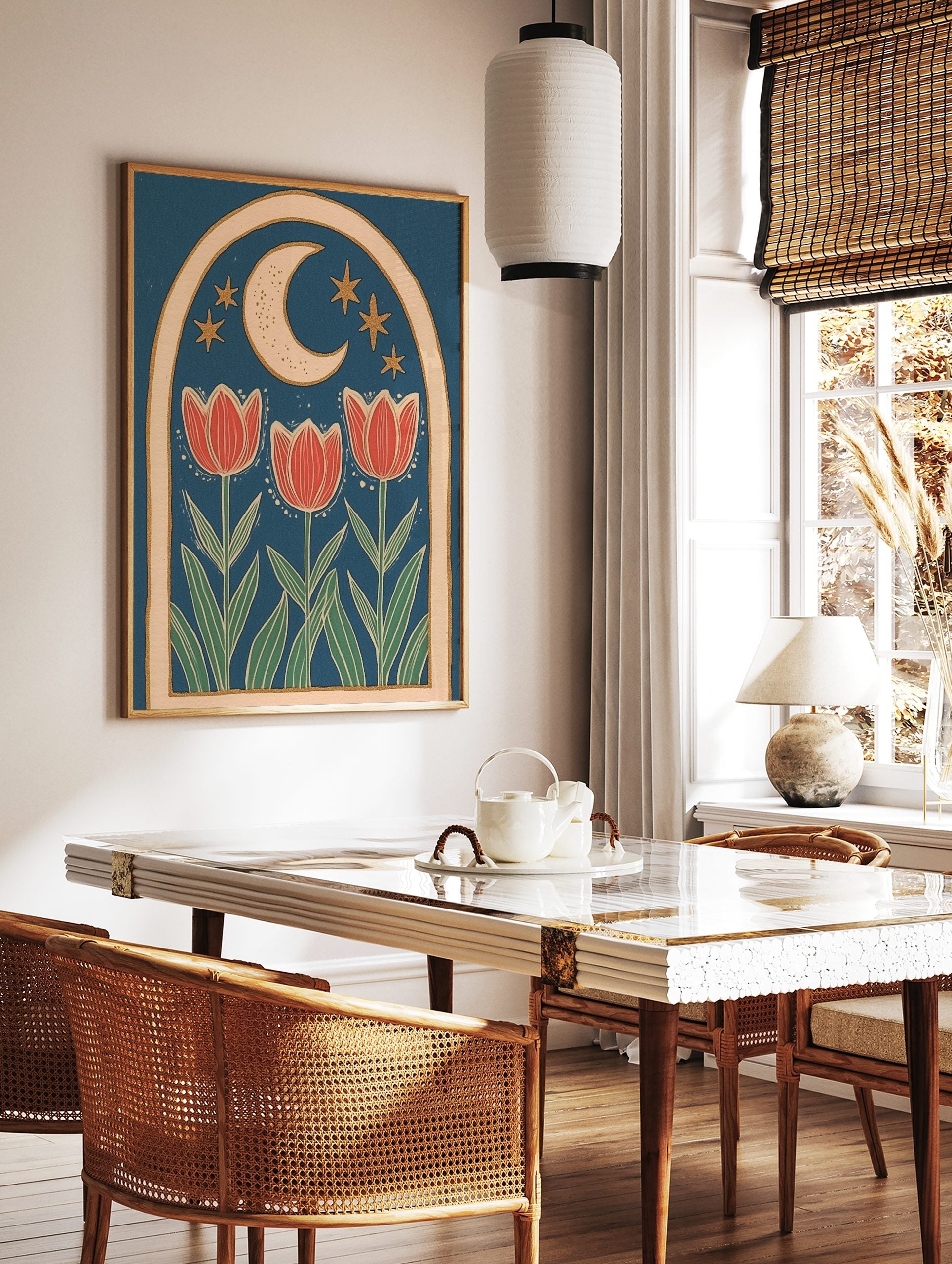 Illustrative folk art print with three red tulips, crescent moon, and golden stars within an arched, in a styled room mockup