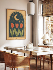 Illustrative art print with three red tulips under a golden crescent moon and stars in a dark blue, in a styled room mockup