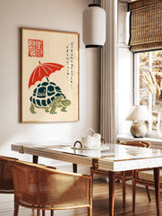 Illustrative print of a turtle with a red umbrella, Japanese script, and red seal on a cream, in a styled room mockup
