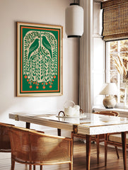 Illustrative green art print of two birds in a leafy tree with orange berries and a green-orange, in a styled room mockup