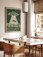 Illustrative woodcut style print of a UFO abducting a striped tiger with a light beam over a forest, in a styled room mockup