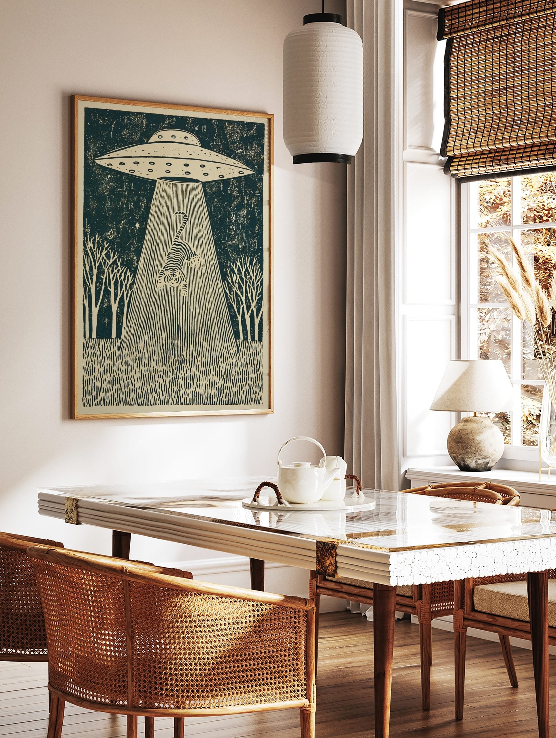 Linocut-style print of a striped tiger being abducted by a UFO's tractor beam, set in a forest, in a styled room mockup