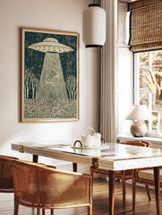 Linocut-style print of a striped tiger being abducted by a UFO's tractor beam, set in a forest, in a styled room mockup