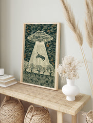 Linocut style wall art of a striped tiger being abducted by a UFO's beam over a forest at, in an alternate framed mockup