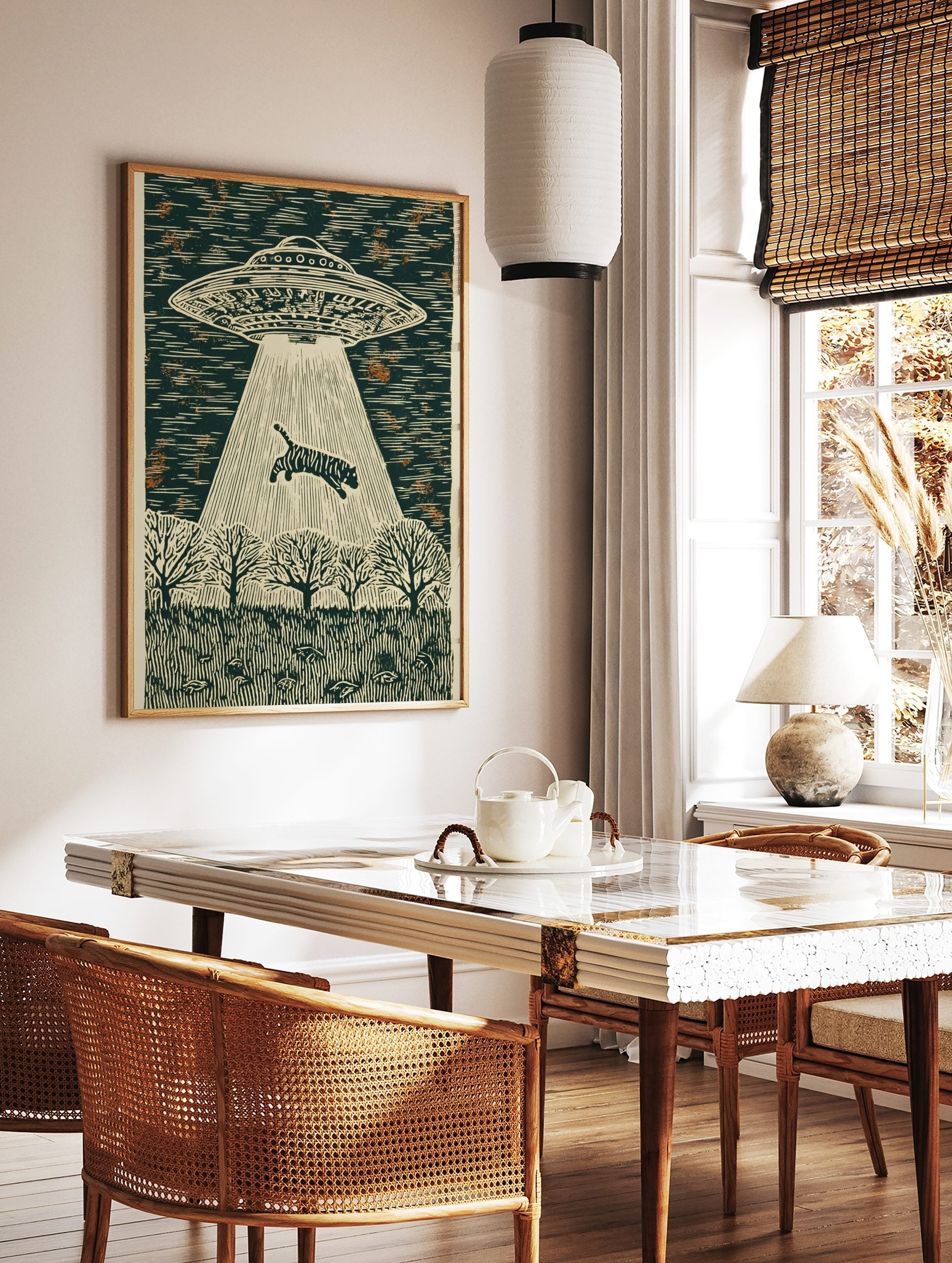 Linocut style wall art of a striped tiger being abducted by a UFO's beam over a forest at night, in a styled room mockup