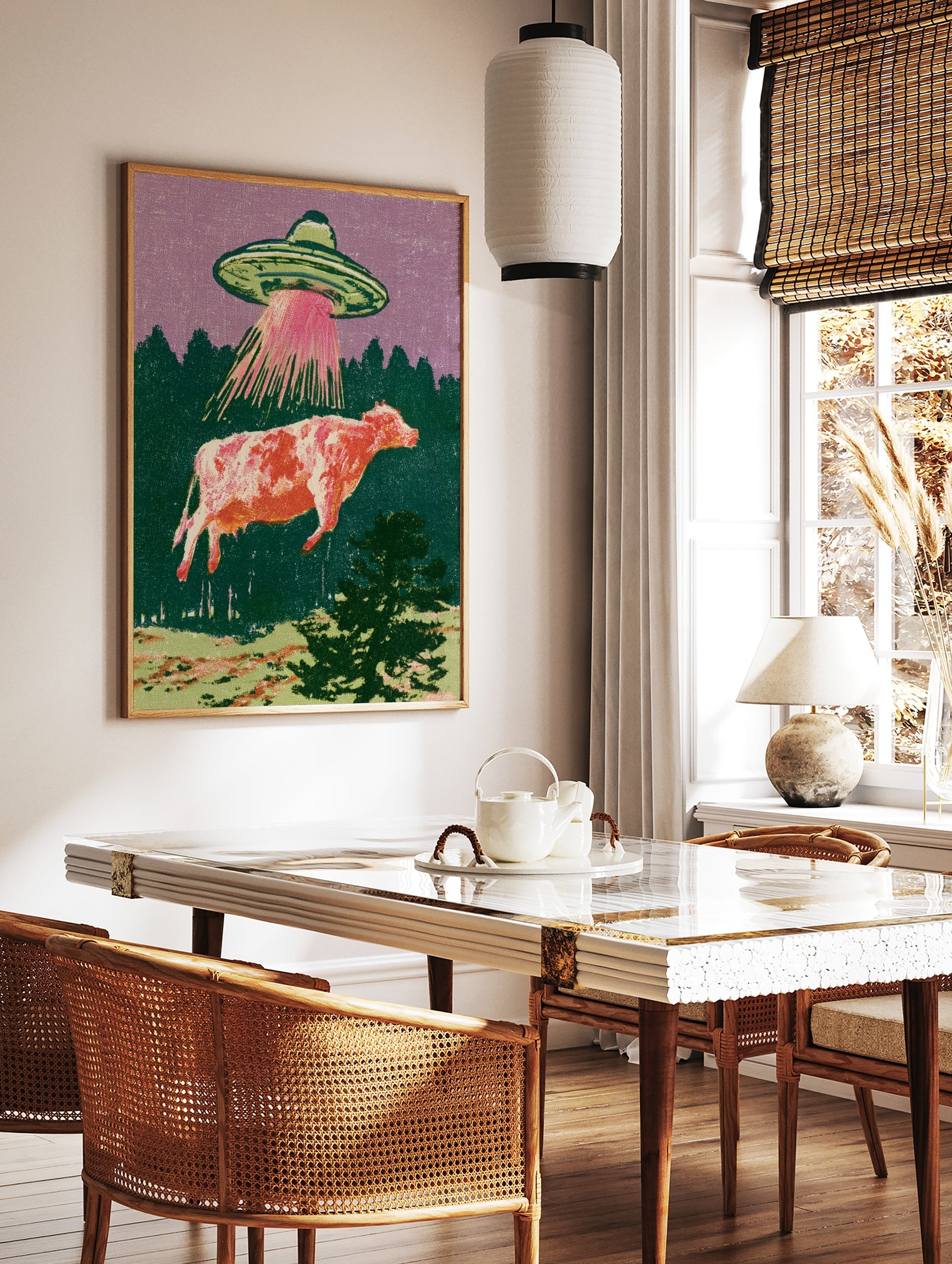 Retro illustration of a UFO abducting a cow with a pink tractor beam against a purple sky and green, in a styled room mockup