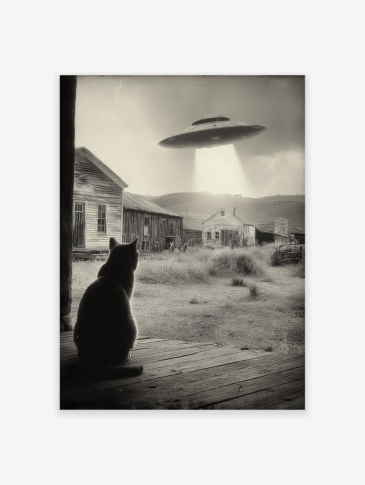 Black and white UFO Cat Wall Art showing a cat on a porch looking at a UFO hovering over old houses in a rural setting.