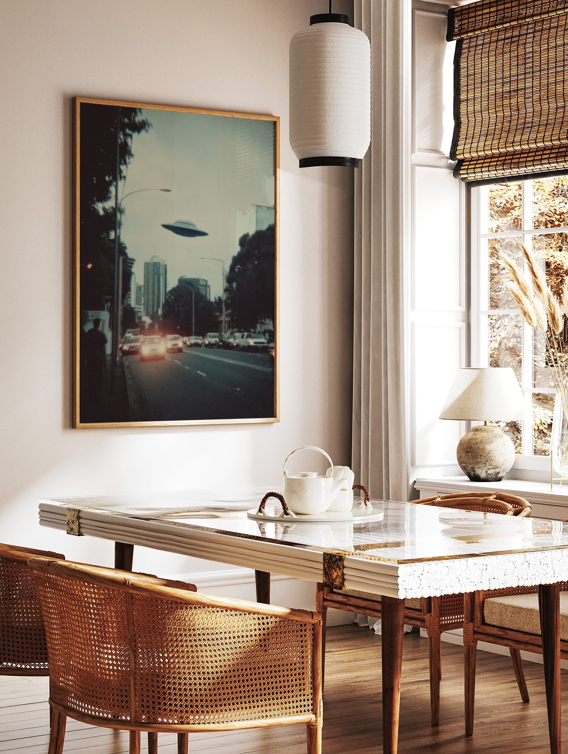 Retro sci-fi print of a UFO flying over a city skyline with cars and buildings at dusk, in a styled room mockup