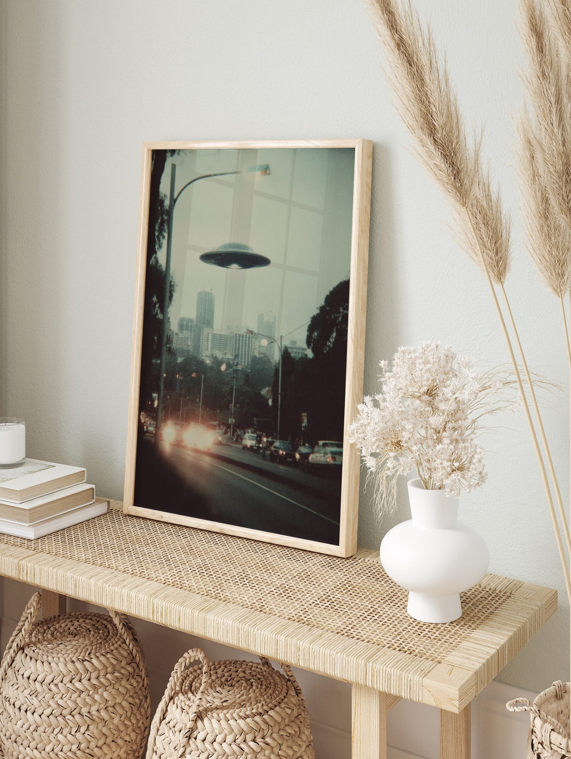 Retro photographic print of a flying saucer hovering over a hazy city street with car, in an alternate framed mockup
