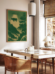 Surreal UFO abduction scene with a cow floating above a dark green forest, illustrated poster print, in a styled room mockup