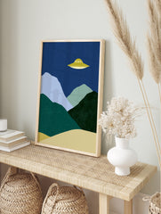 Modern UFO landscape wall art print featuring minimalist mountains and a yellow UFO against a, in an alternate framed mockup