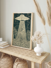 UFO abducting a striped tiger in a dark forest scene, illustrative linocut style wall art, in an alternate framed mockup
