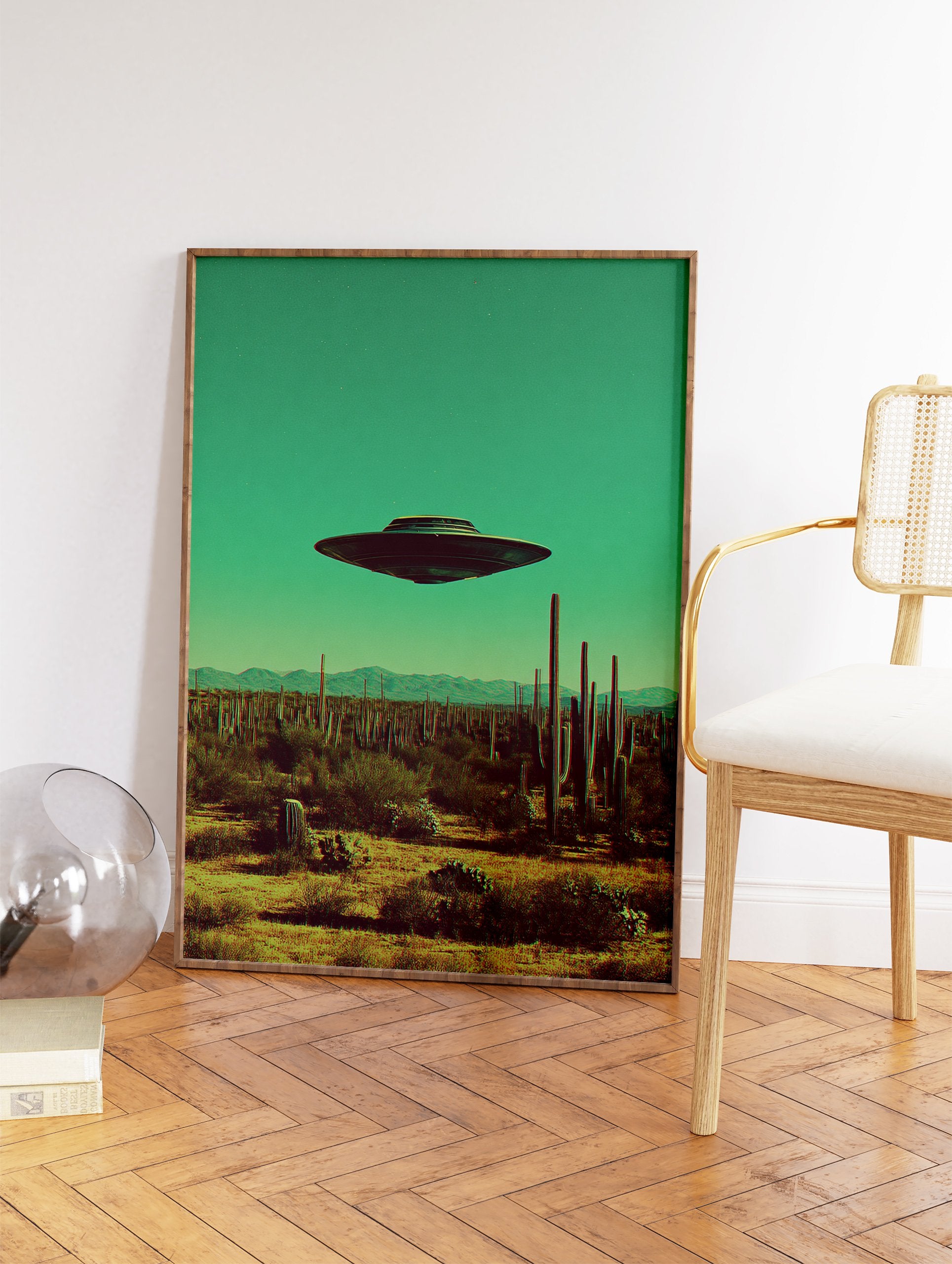 UFO flying saucer hovering over a desert landscape with saguaro cacti under a teal sky, retro sci-fi art print. - Image 2