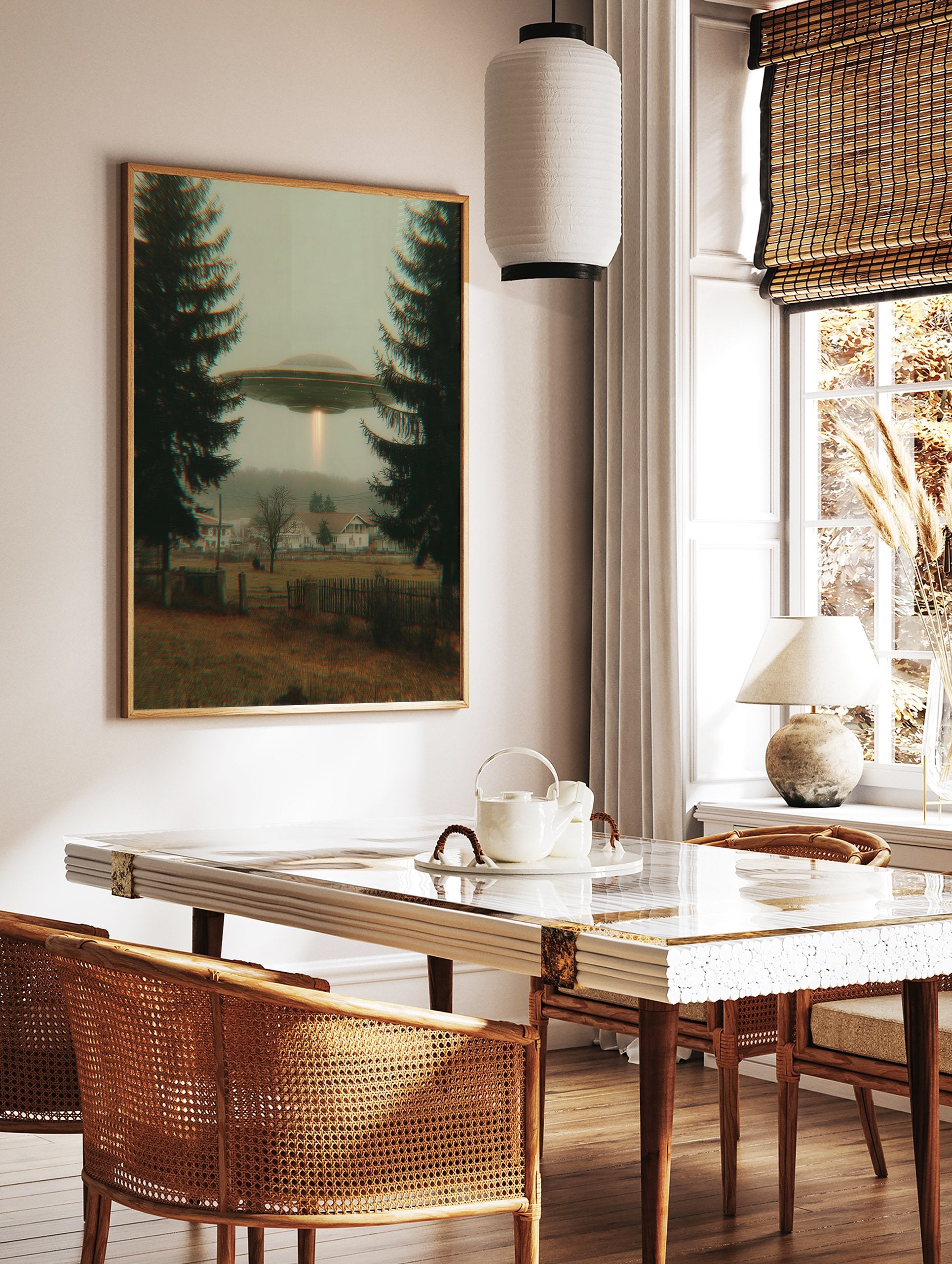 UFO flying saucer with a light beam hovers over a misty village framed by two dark evergreen trees. Mysterious sci-fi wall art. - Image 3
