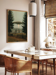UFO flying saucer with a light beam hovers over a misty village framed by two dark evergreen trees. Mysterious sci-fi wall art. - Image 3