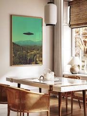 UFO flying saucer hovering over a desert landscape with saguaro cacti and mountains under a teal sky, surreal wall art. - Image 3