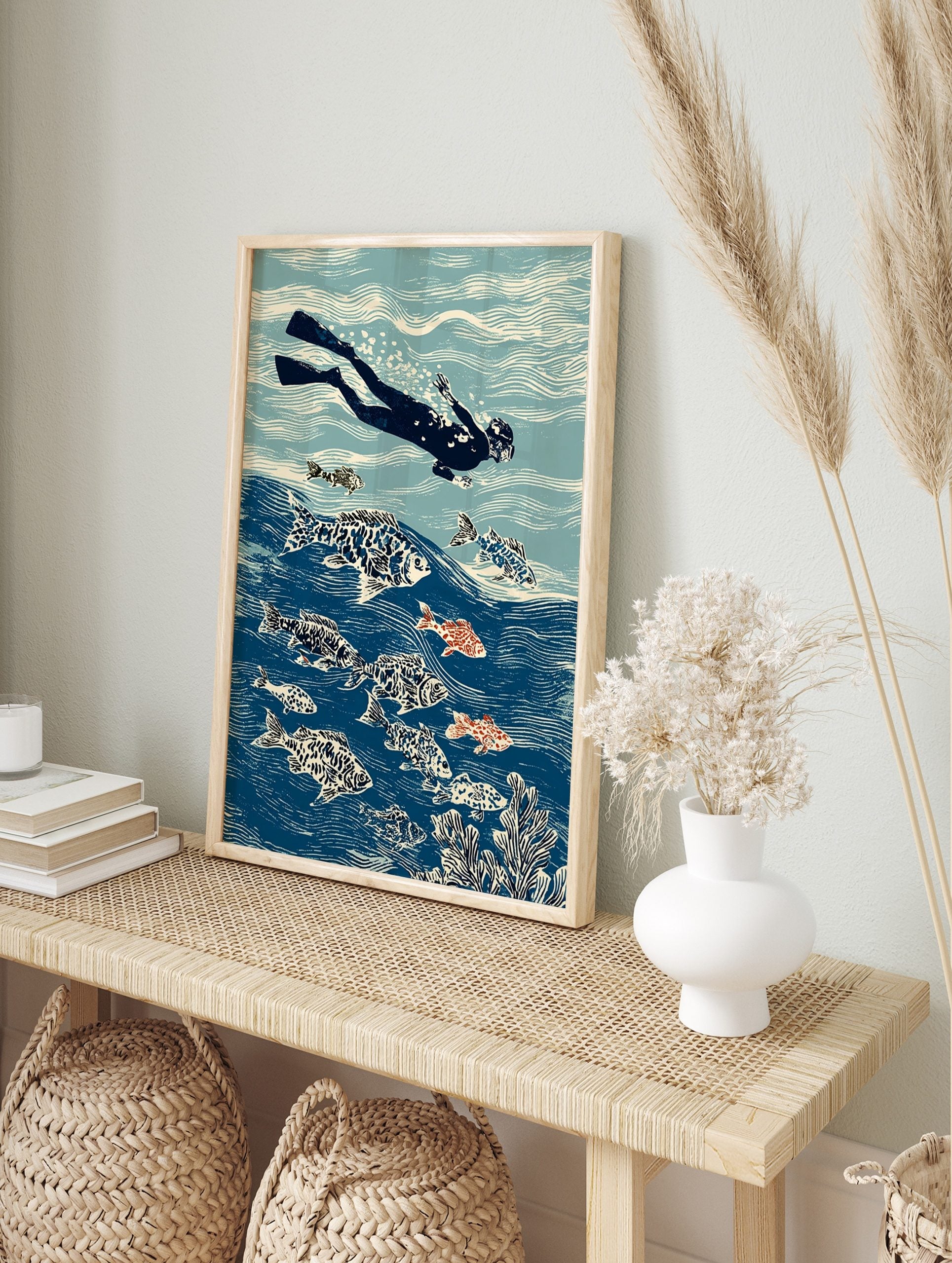 Illustrative print of a freediver swimming with patterned fish and coral in a blue ocean, in an alternate framed mockup