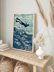 Illustrative print of a freediver swimming with patterned fish and coral in a blue ocean, in an alternate framed mockup