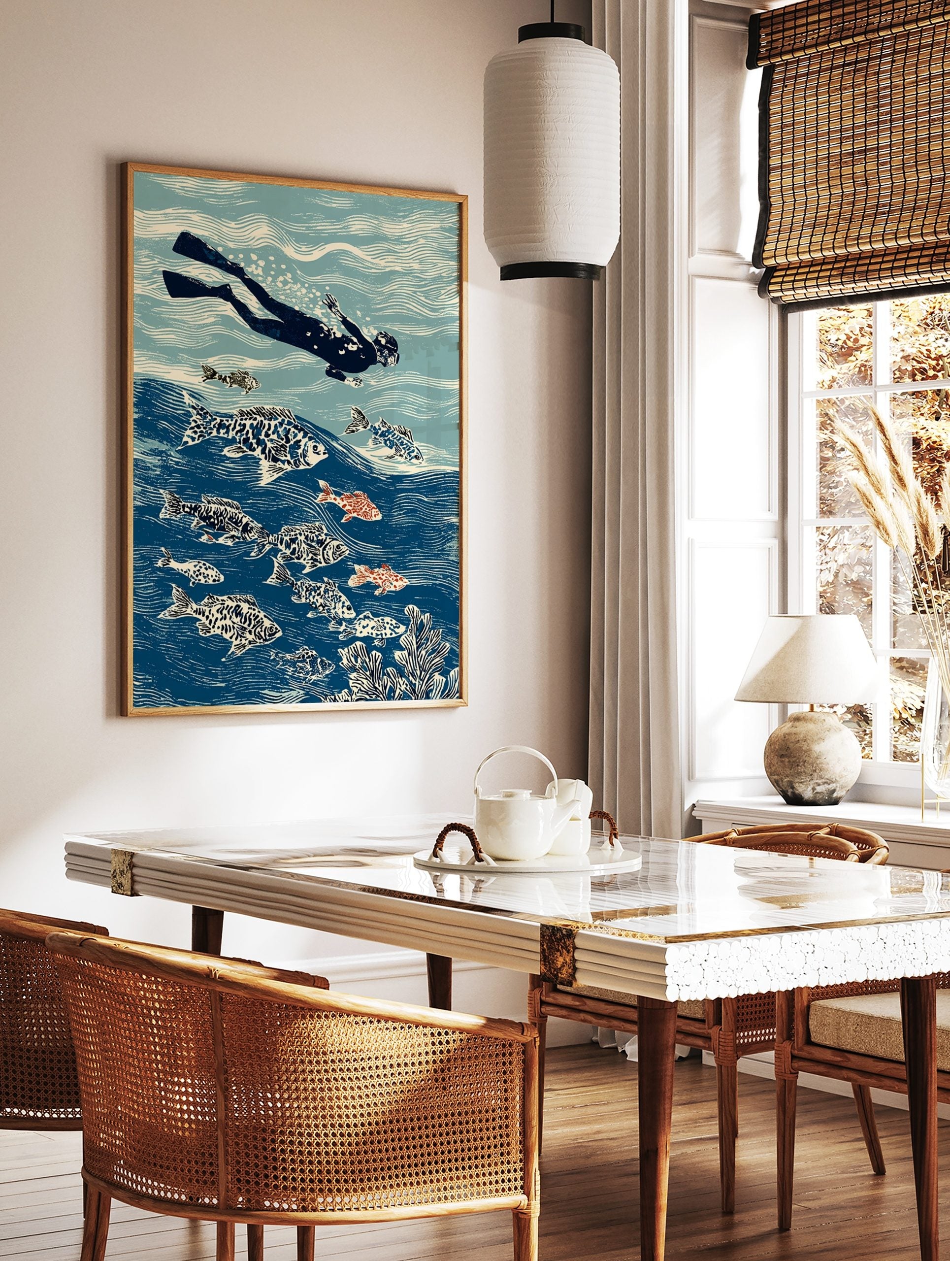 Illustrative print of a freediver swimming with patterned fish and coral in a blue ocean, in a styled room mockup
