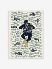Illustrative print of a navy blue scuba diver with olive flippers swimming among fish and water ripples