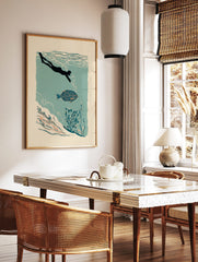 Illustrative print of a diver swimming with a patterned blue fish in teal water with underwater, in a styled room mockup