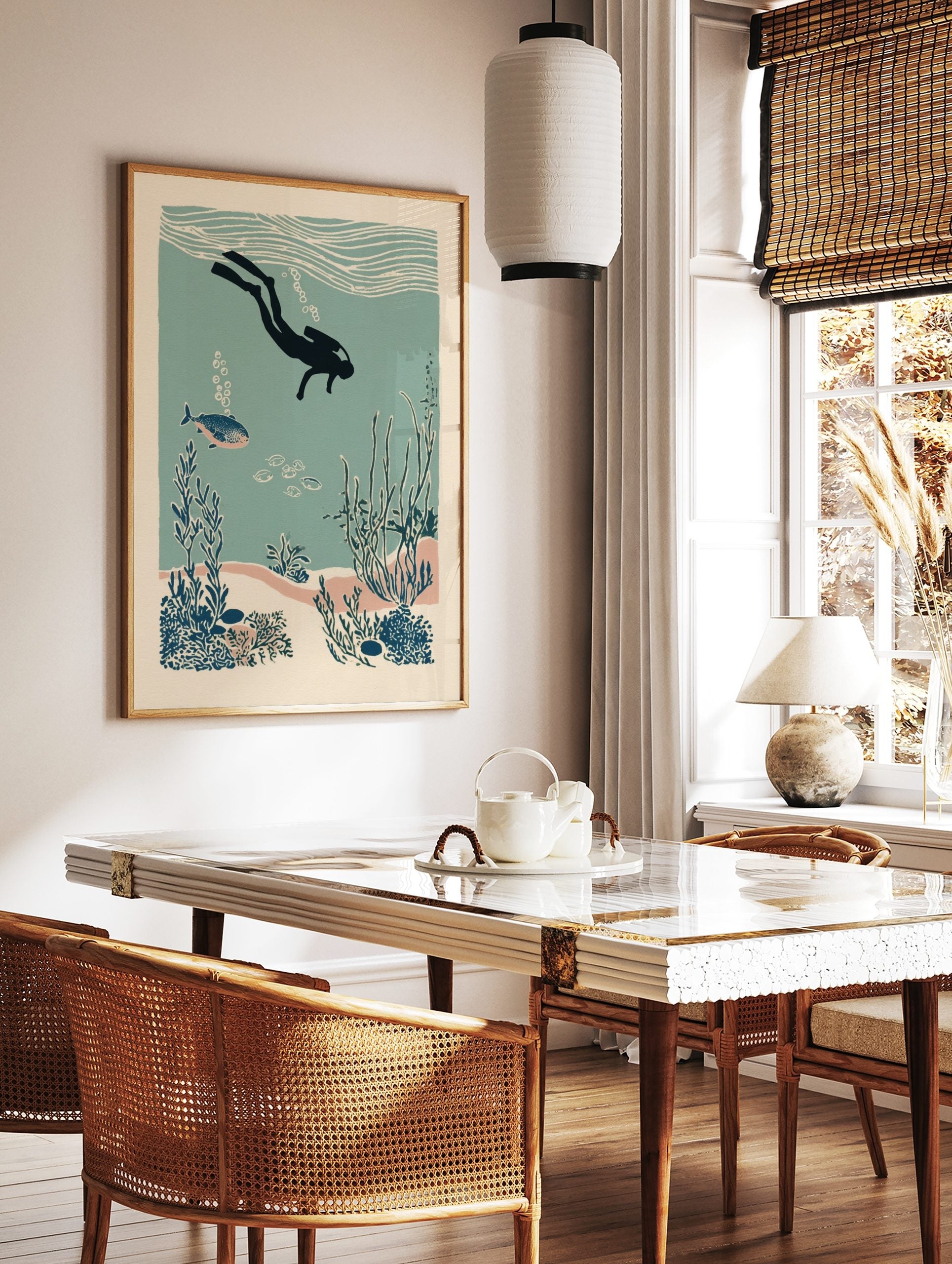 Illustrative scuba diver exploring an underwater coral reef with fish and seaweed in teal and blue, in a styled room mockup