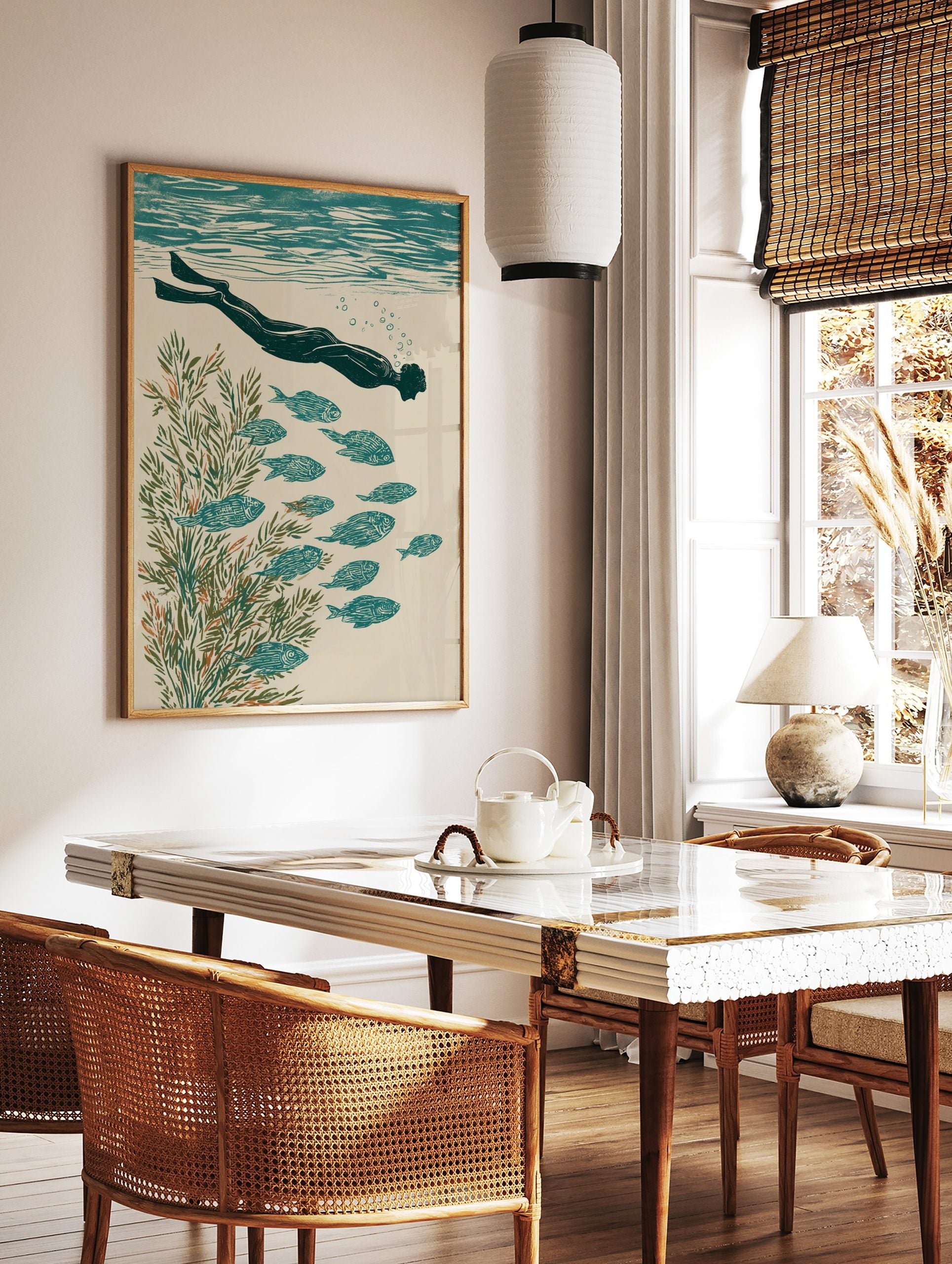 Illustrative print of an underwater swimmer with fins, school of fish, and green seaweed in teal, in a styled room mockup