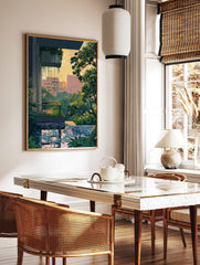 Urban oasis cityscape print with green foliage, modern buildings, and reflective pool at sunset, in a styled room mockup