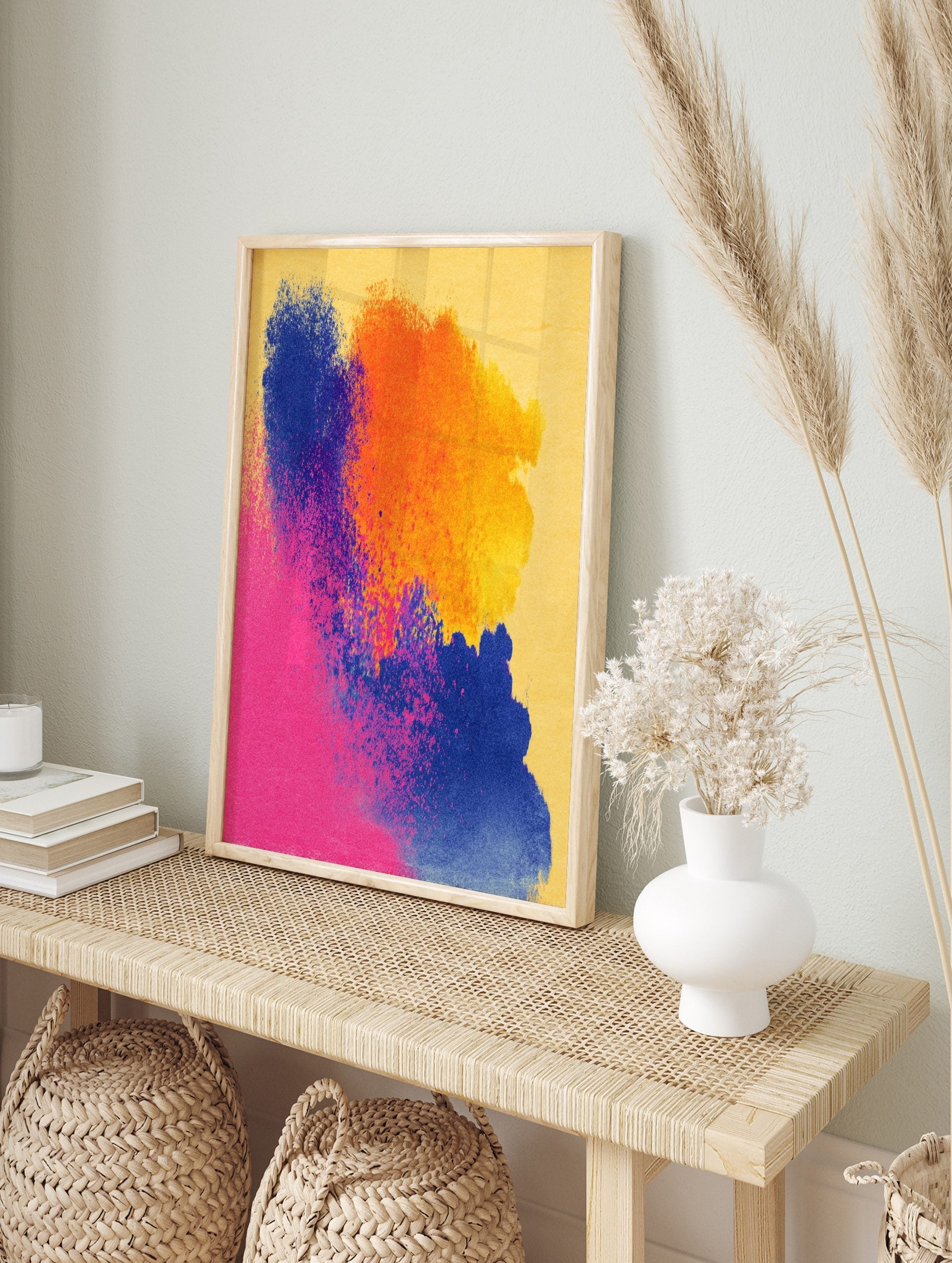 Abstract art print with vibrant pink, blue, and orange colour splashes on a yellow, in an alternate framed mockup