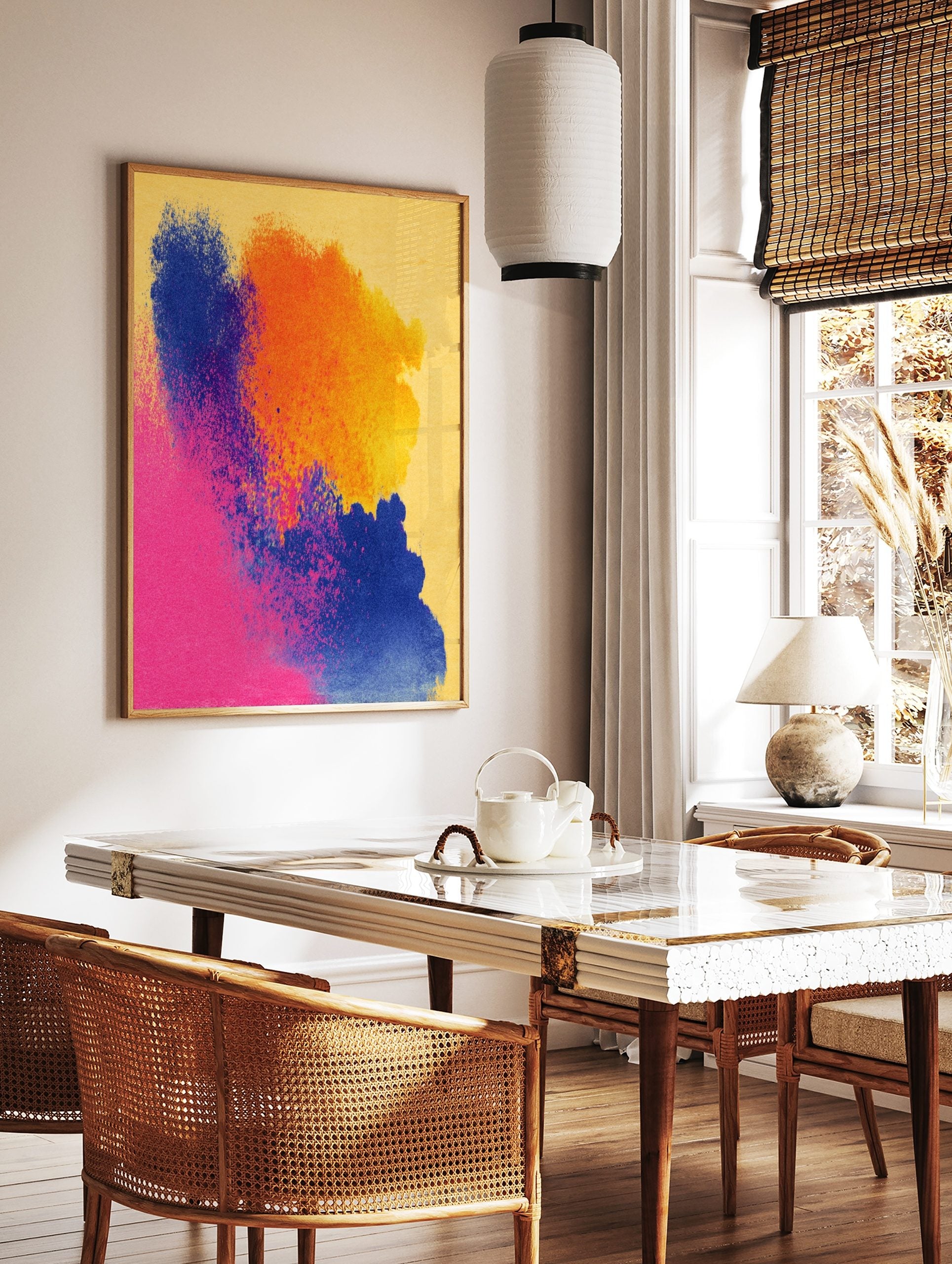 Abstract art print with vibrant blue, orange, and pink powder splashes on a yellow background, in a styled room mockup