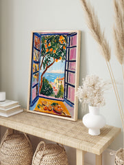 Vibrant orange tree poster with a coastal view of the sea and town through a window, featuring a still life of oranges. - Image 4