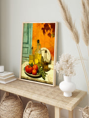Still life print with olive oil bottles, red tomatoes, and basil against an orange wall and, in an alternate framed mockup