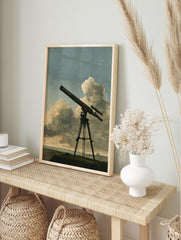 Vintage telescope illustration on a tripod against a cloudy sky, astronomical art print, in an alternate framed mockup