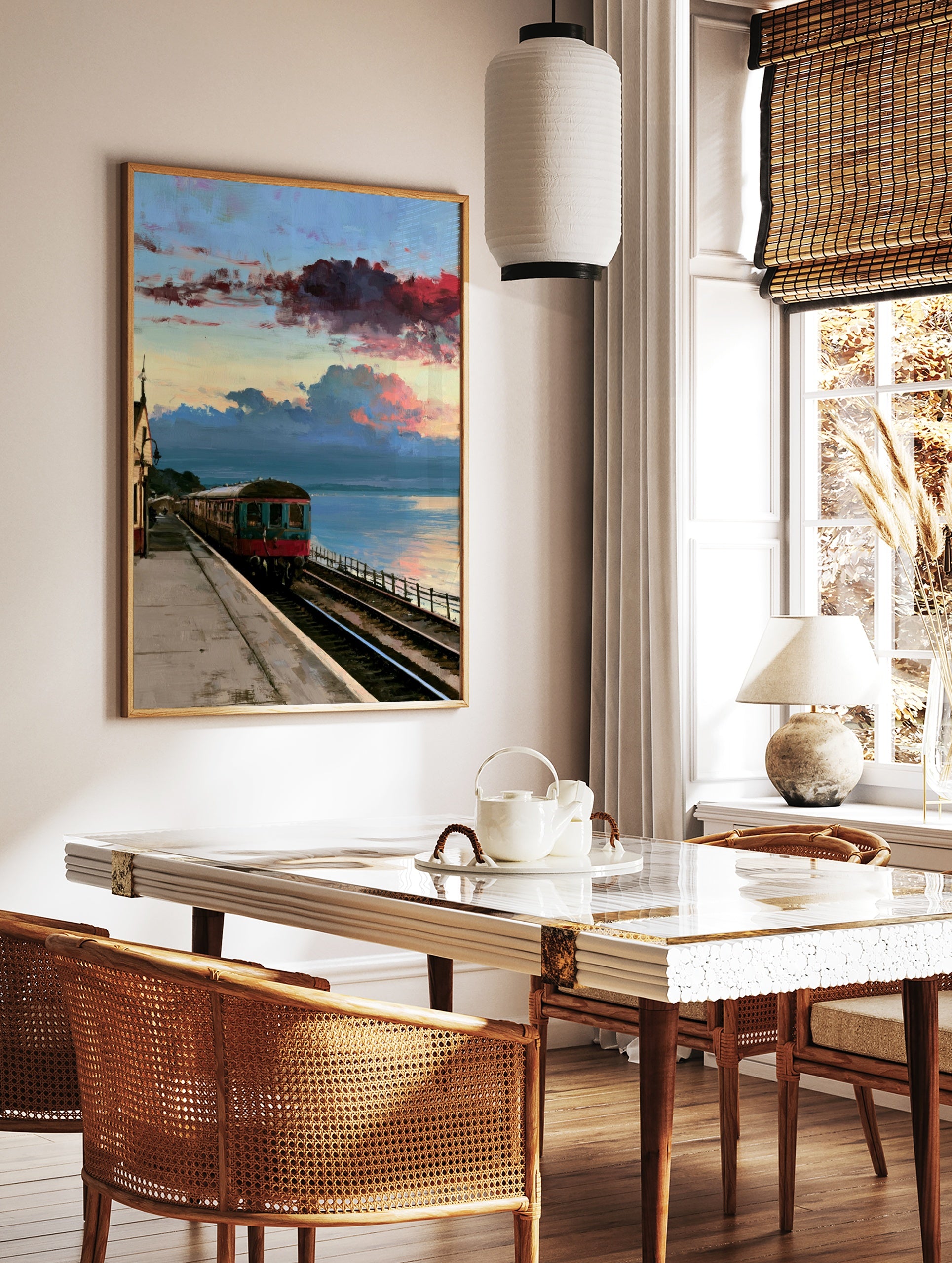 Vintage train carriage at a coastal railway station under a dramatic red and blue sunset sky, in a styled room mockup
