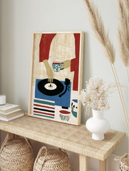 Illustrative art print of a person holding a tea cup and touching a vinyl record on a blue, in an alternate framed mockup