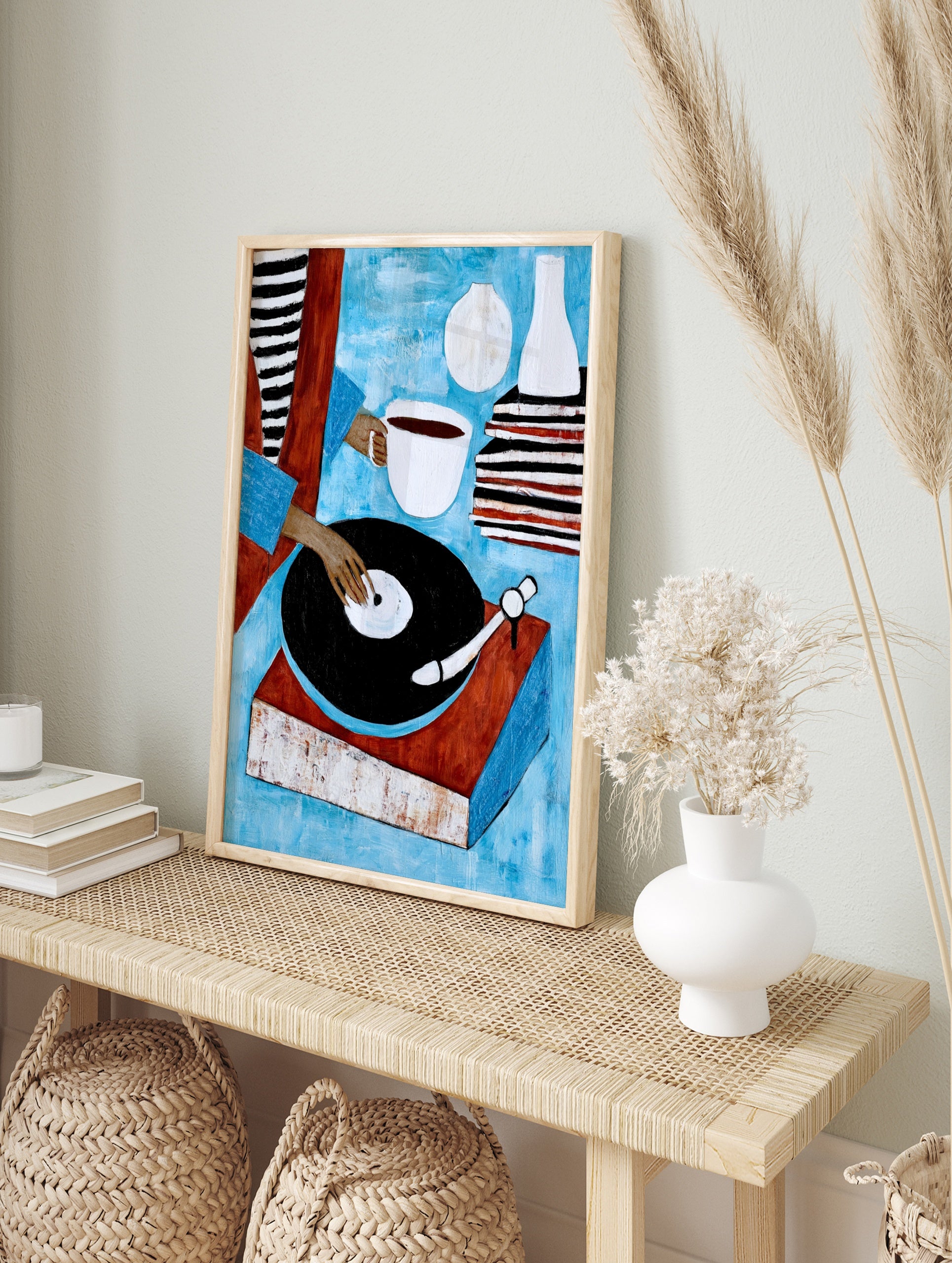 Illustrative art print of a person using a vinyl record player with a coffee cup and stacked, in an alternate framed mockup