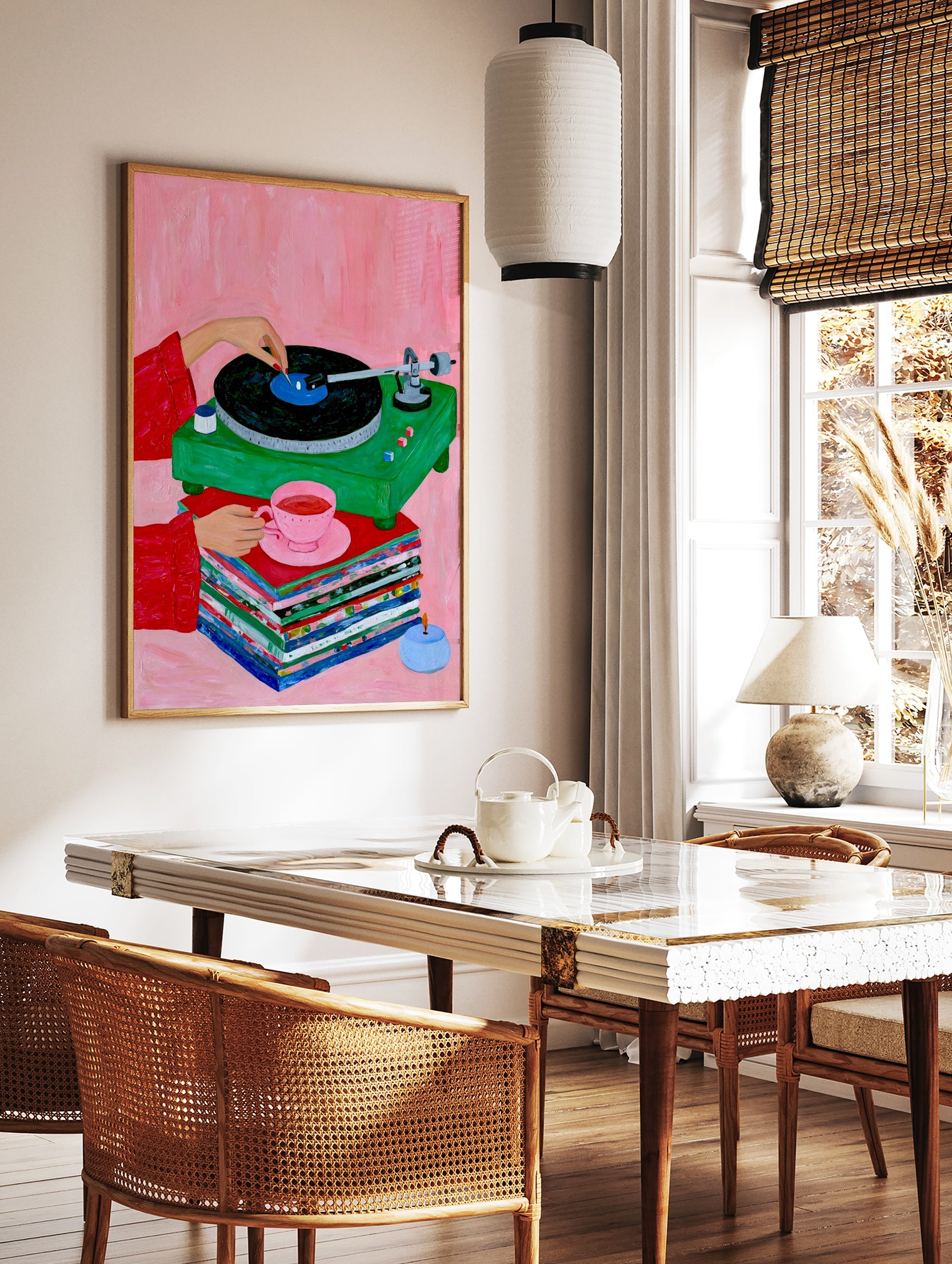 Illustration of a green vinyl record player, stacked records, and a pink teacup on a pink background, in a styled room mockup