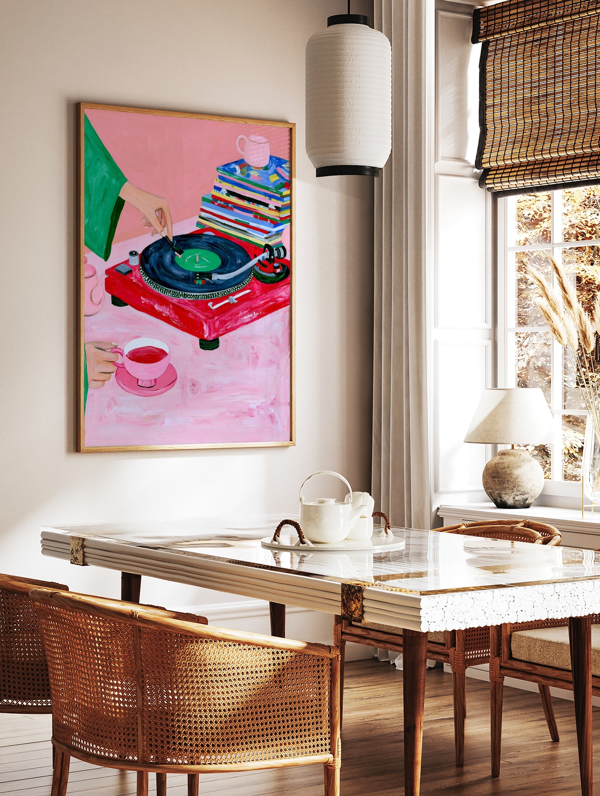 Illustrative art print of a red vinyl record player, tea set, and magazines on a pink background, in a styled room mockup