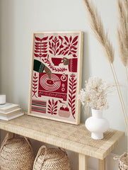 Stylised red and cream illustration of a hand playing a vinyl record, surrounded by botanical, in an alternate framed mockup
