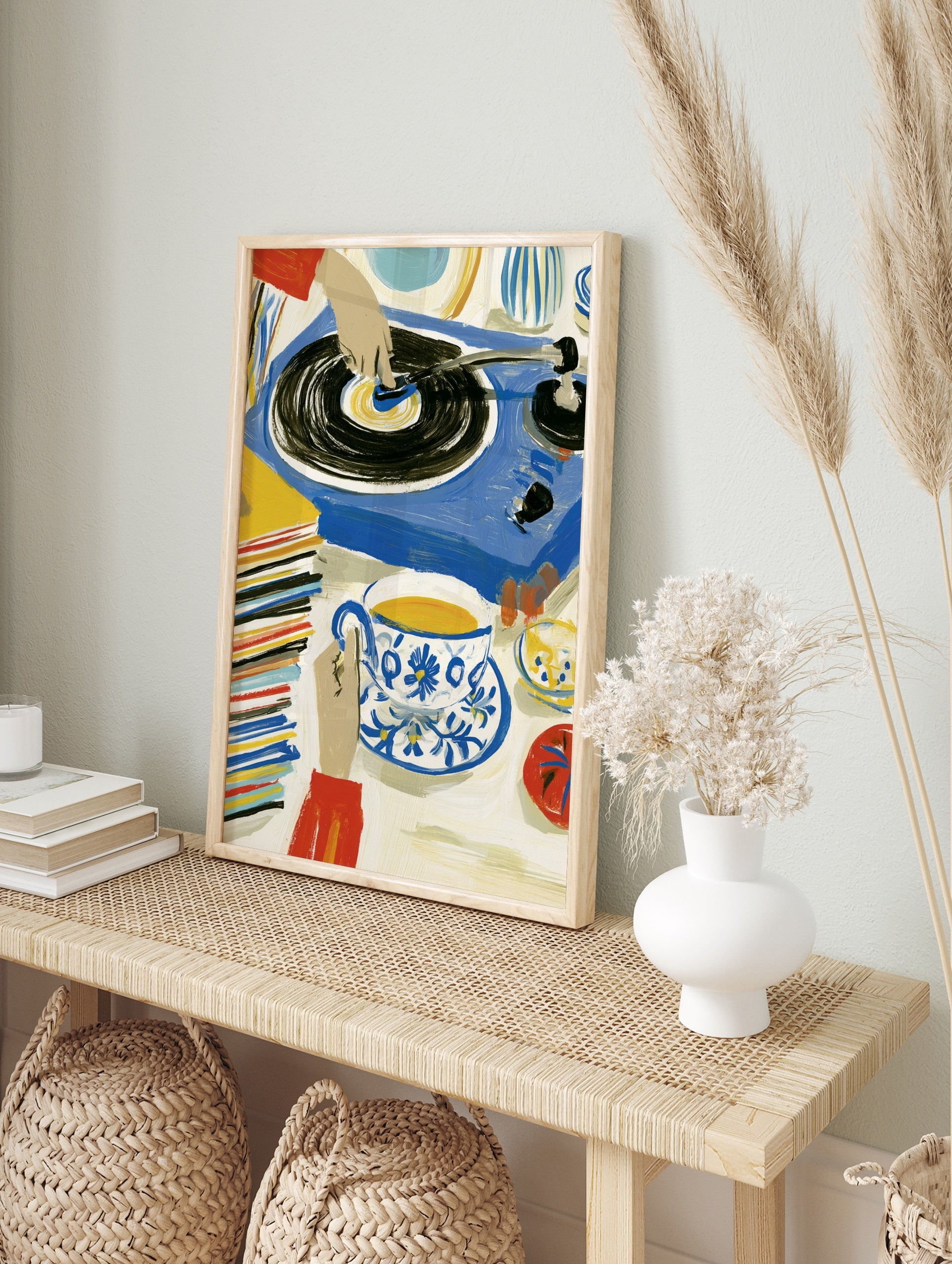 Illustrative art print of a hand on a vinyl record player with tea and a stack of records in, in an alternate framed mockup