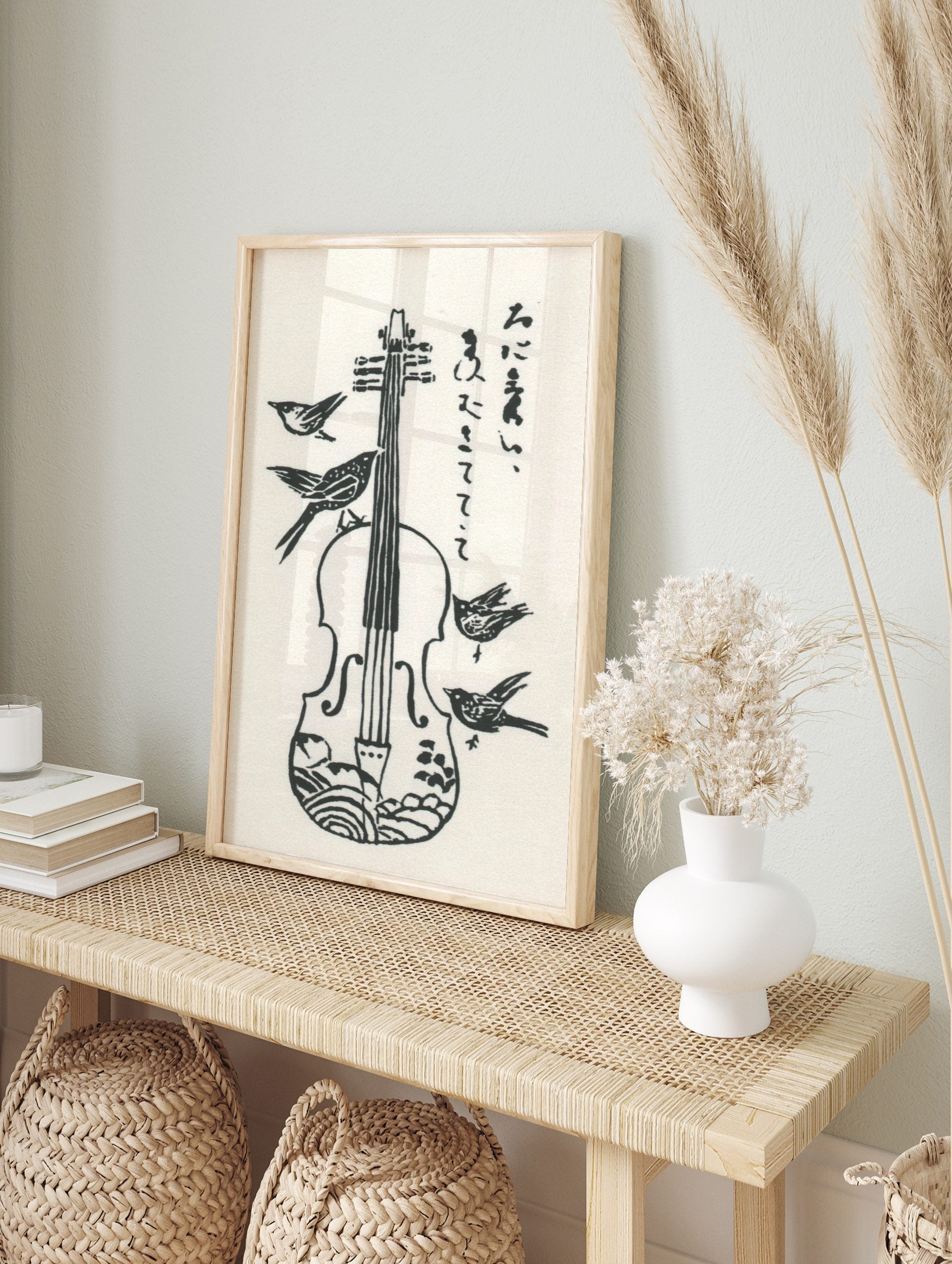 Monochrome woodcut style print of a violin with four birds and vertical Japanese script, in an alternate framed mockup