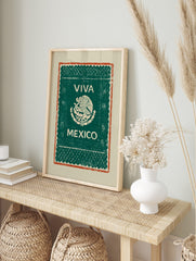 Viva Mexico wall art with eagle and serpent emblem, 'VIVA MEXICO' text, green background, and, in an alternate framed mockup