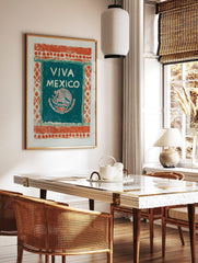 Viva Mexico art print with an eagle, snake, and cactus emblem on a teal-green panel with an, in a styled room mockup