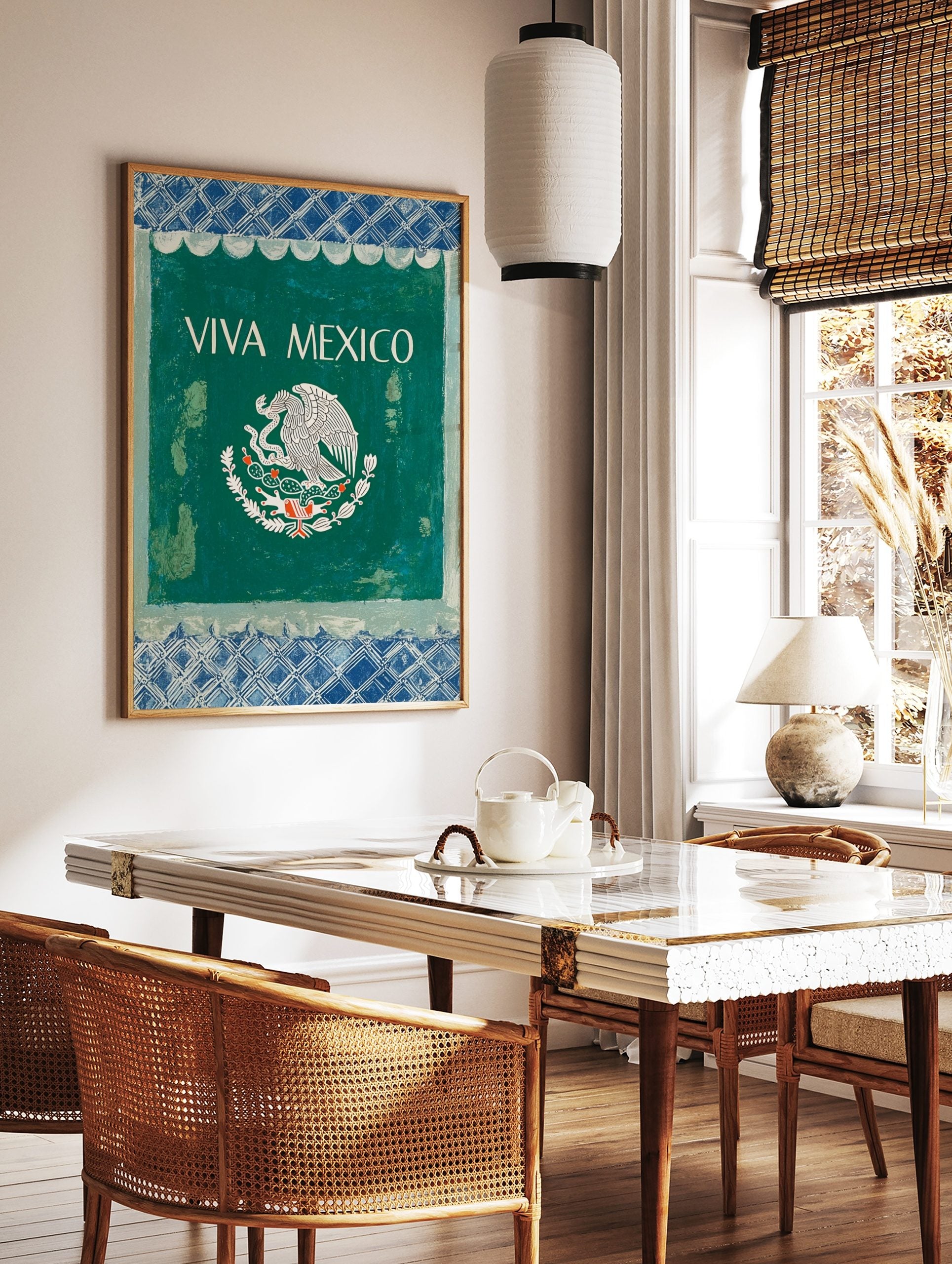VIVA MEXICO wall art with white text and Mexican eagle emblem on dark green, framed by blue, in a styled room mockup